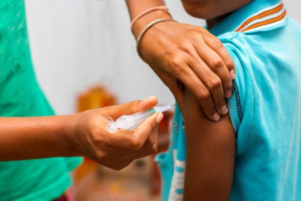 a child is vaccinated by a doctor.